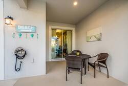 Step onto your private patio, where cozy wicker chairs invite you to unwind. The subtle beach-themed decor and soft lighting create a calming ambiance, perfect for sipping morning coffee or evening cocktails as you plan your day.