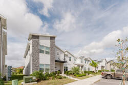 Step into a vibrant community where contemporary architecture meets lush landscaping. This stylish exterior features clean lines and a charming stone façade, inviting you to explore the inviting surroundings and unwind in comfort.