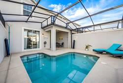 Discover your private oasis with a sparkling pool and spacious patio surrounded by sleek tiles. Relax on inviting lounge chairs to soak up the sun, all within a comfortable, breezy screened enclosure.