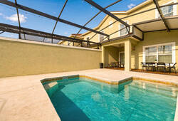 Step outside to your private pool area, where the inviting turquoise water awaits. The spacious, screened deck provides comfort and beautiful views, perfect for relaxing on sunny afternoons or enjoying evening gatherings.