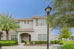 Step outside to admire the charming exterior, where palm trees sway next to the inviting entrance. The warm, neutral tones of the stucco walls and decorative shutters offer a welcoming touch, setting the stage for your stay.