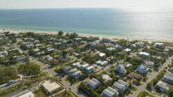 Experience stunning coastal views from this charming neighborhood, where the shimmering ocean meets a serene landscape of inviting homes. The vibrant blue waters and lush greenery create a picturesque backdrop for your stay.