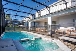 Enjoy a private screened pool with a raised spa, sunny deck, lounge chairs, outdoor seating, and dining space, perfect for relaxing, swimming, and sharing vacation moments in Florida.
