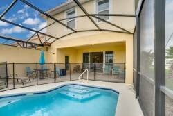 Step outside to enjoy a private pool area with a stylish screen enclosure, perfect for sunbathing under the bright blue sky. Relax on the comfortable seating and unwind in the gently bubbling spa for a luxurious experience.