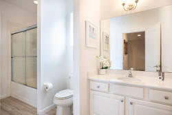 Enjoy a bright, stylish bathroom with a glass-enclosed shower and a spacious vanity with a polished countertop. The soft, neutral colors create a soothing atmosphere, ideal for relaxing after your day of adventure.