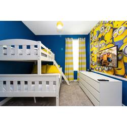 This cheerful children's bedroom boasts a white bunk bed and vibrant blue walls adorned with a fun Minions mural, complemented by a cozy yellow chair and soft carpeting, creating an inviting space for kids to play and relax.