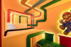 Step into a whimsical bedroom featuring vibrant colors and playful geometric designs that bring a unique charm. The glowing LED accents highlight the cozy bedding, creating a delightful atmosphere perfect for relaxation and fun.