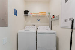 Effortlessly tackle laundry during your stay with the convenient washer and dryer tucked away in this tidy nook. Enjoy the practicality of well-organized shelves and fresh linens on hand, making your vacation feel just like home.