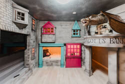 Enter a whimsical play area with a delightful miniature village adorned in vibrant pink and turquoise. Its charming details and imaginative design inspire creativity and fun, making it the perfect backdrop for memorable moments.