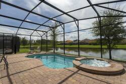 Discover your private oasis with a sparkling pool and soothing spa, all enclosed for your comfort. Stroll along inviting paver stones to enjoy serene water views, ideal for relaxing afternoons under the sun.
