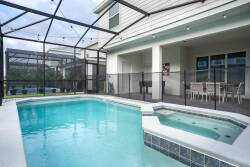 Step outside to your private oasis, where a sparkling pool awaits, framed by sleek tile and surrounded by a spacious patio. Enjoy al fresco dining under the protective screen as you soak in the sun-drenched atmosphere.