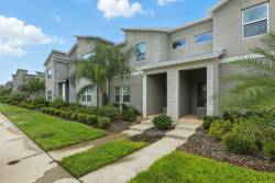 Step outside to experience the vibrant palm-framed landscaping that welcomes you to your home away from home, with a well-maintained path leading to a charming facade, ideal for relaxation after your daily adventures.