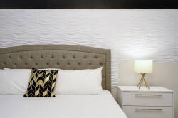 Enjoy peaceful nights in this beautifully designed bedroom with a plush tufted headboard and chic accent pillow. Soft lighting from the bedside lamp creates a warm, inviting atmosphere, perfect for unwinding after your adventures.