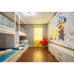 Bright and cheerful, this playful kids' room features a fun Minion mural that sparks imagination and adventure. With cozy bunk beds in calming blue tones and a vibrant red chair, it’s a delightful space for young guests to unwind.