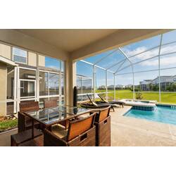 Enjoy the screened patio with outdoor dining, lounge chairs, private pool, relaxing spa, sunny views, and open green surroundings, perfect for peaceful moments by the water.