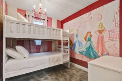 This charming children's room features a cozy white bunk bed perfect for bedtime stories, a whimsical princess mural for a playful touch, and a soft, plush carpet that adds comfort and warmth for your little ones.