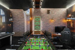 Experience our stylish game room, complete with a vibrant foosball table for friendly competition, rich brick walls, and sleek leather seating, all enhanced by warm lighting to create an inviting atmosphere for unforgettable fun.