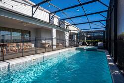 Enjoy a private screened pool with a raised spa, sunny deck, lounge chairs, outdoor seating, and dining space, perfect for relaxing, swimming, and sharing vacation moments in Florida.