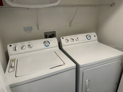 Experience convenience in this laundry area with a sleek washer and dryer that make caring for your clothes easy during your stay. The clean white appliances enhance the bright space, turning chores into a breeze.