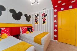 Welcome to a lively kids' room filled with playful charm, bright yellow accents, and beloved character decor. The bold red and polka-dotted walls set the stage for imaginative adventures and restful nights.