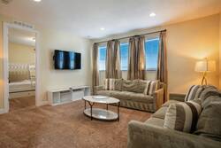 Relax in the cozy living room, where soft, plush seating invites you to unwind. The warm hues of the decor, combined with gentle natural light filtering through the windows, create a welcoming atmosphere for your stay.