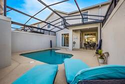 Discover your private oasis with a sparkling pool inviting you to relax under a protective screen. The soothing turquoise loungers enhance the sleek, modern architecture, creating a tranquil ambiance perfect for unwinding.