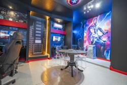 Step into this vibrant gaming room where a striking mural sets the stage for fun. The sleek gaming chairs and modern desks create a dynamic atmosphere, ensuring an exciting retreat for both gamers and casual visitors alike.