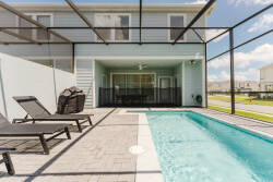 Step outside to your private oasis, where sleek black loungers beckon you to unwind beside the sparkling pool. Enclosed by a stylish screen, this tranquil spot offers a perfect blend of sun and shade, ideal for relaxation.