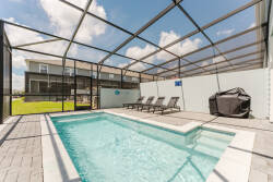 Step into your private oasis with a sparkling pool framed by sleek pavers and a spacious deck. Relax on the comfortable lounge chairs under the expansive screened enclosure, allowing for sunny days and starlit nights.