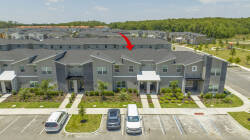 Nestled in a stunning landscape, this stylish vacation home boasts contemporary architecture and a sleek gray facade. Enjoy the well-kept grounds for outdoor relaxation, and convenient nearby parking for your adventures.