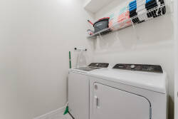 Effortlessly combine convenience and functionality in this dedicated laundry space, featuring sleek, modern appliances and ample shelving for all your essentials, ensuring you enjoy a hassle-free stay without compromising comfort.
