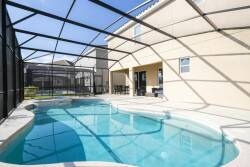 Experience your private oasis with a sparkling pool and stylish screened enclosure that invites natural light. Unwind on the sun-kissed deck, where the sleek design and peaceful ambiance create the perfect retreat for relaxation.