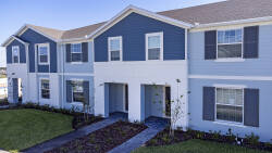 Experience the charm of our inviting blue and white exterior with dark shutters. The landscaped pathway beckons you to discover a world of comfort and relaxation just beyond the entrance.