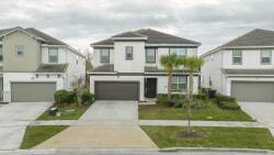 This charming home features a stylish exterior with neutral tones and clean lines, complemented by beautiful landscaping. Guests can relax on the inviting front porch, enjoying peaceful moments amid the lush greenery.