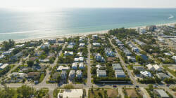Enjoy coastal living with breathtaking views of sunlit streets and charming homes just steps from the beach. The vibrant blue ocean beckons you to discover the beauty of the nearby shoreline.