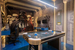 Enter a themed game room with sleek blue flooring and iconic wall art of beloved characters. The clever lighting and stylish decor create an energetic vibe, ideal for enjoying friendly competition with friends.
