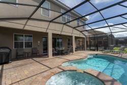 Step into your private oasis with a sparkling pool and bubbling spa, bordered by a spacious brick patio ideal for lounging. The screened enclosure lets you fully enjoy the sunny Florida skies while you relax.