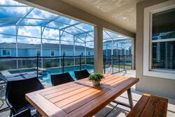 Have fun in a superhero themed game garage with a ping pong table, bold wall art, ceiling fan, playful red and blue accents, and open space, creating a great area for family entertainment during vacation.