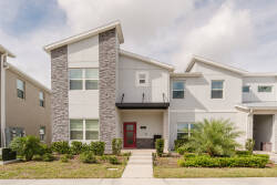 Experience this charming vacation home with its stunning stone façade and modern lines, highlighted by a vibrant red door. Surrounded by lush landscaping, it’s the perfect place for relaxation and enjoyment during your stay.