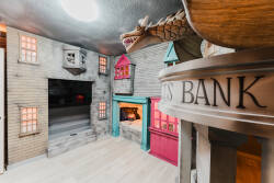 Step into a whimsical playroom featuring charming wooden structures that resemble a vibrant village, complete with colorful accents and a dragon motif. The unique design invites fun and creativity, perfect for all ages to enjoy.