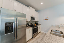 Welcome to this gorgeous kitchen, where sleek stainless steel appliances and beautiful granite countertops blend style and functionality.