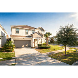 Arrive at a beautiful two-story vacation home with a spacious driveway, garage, manicured lawn, and sunny neighborhood views. Palm trees, bright natural light, and a welcoming entrance create a warm first impression for your stay.