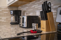 Enjoy the convenience of our well-equipped kitchen with granite countertops and a stylish knife block. Modern appliances like a coffee maker and toaster make meal prep easy in this inviting space.