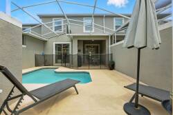 Step outside to your private oasis featuring a sleek pool, surrounded by a spacious patio perfect for lounging. The modern decor includes stylish chaise lounges and a generous umbrella, inviting you to unwind under the sun.