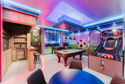 Enter our lively game room, where bright LED lights set the stage for fun and laughter. Enjoy friendly competition on the classic pool table and arcade games, all while relaxing at our cozy bar area for refreshments.