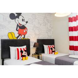 Enjoy a cheerful Mickey-themed bedroom with two comfortable beds, red and white striped accents, character pillows, playful wall art, soft lighting, and cozy decor for kids.