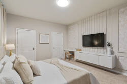 Rest in a serene bedroom with a cozy bed, tufted headboard, soft beige curtains, warm lamps, wall-mounted TV, and neutral decor, creating a calm space to relax during vacation.