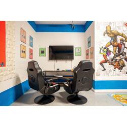 Enjoy a fun gaming corner with two comfortable gaming chairs, a wall-mounted TV, console setup, and colorful game controller art. Bold blue accents and superhero wall decor create an exciting space for kids, teens, and adults.