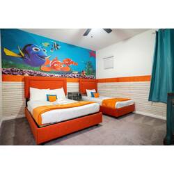 Rest in a bright Finding Nemo themed bedroom with two cozy beds, ocean-inspired mural, orange accents, soft carpet, and teal curtains. Playful sea details and cheerful colors create a fun space for kids during vacation.