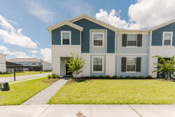 Step outside to admire the charming curb appeal of this home, featuring a delightful blue-and-white exterior and a well-kept lawn. The inviting pathway leads to a warm entrance, creating a welcoming atmosphere for your stay.